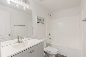 Bathroom with vanity, shower / bathtub combination, and wood finished floors