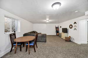 Dining room with a textured ceiling and carpet floors