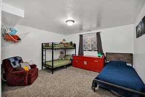 Bedroom featuring a textured ceiling and carpet flooring