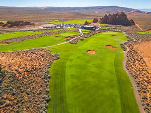 Drone / aerial view of a mountain backdrop and a local golf course