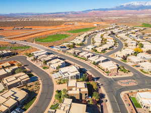 Aerial overview of property's location featuring a mountainous background and nearby suburban area