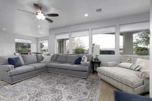 Living area featuring carpet flooring, recessed lighting, and ceiling fan