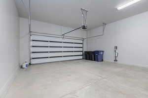 2 car garage featuring baseboards and a garage door opener