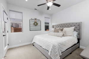 Carpeted bedroom 4 with baseboards and a ceiling fan. Each bedroom has it's own walk-in closet