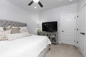 Bedroom 5 with light carpet and ceiling fan