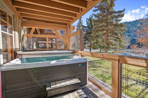 Wooden terrace with a hot tub