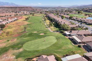 View of property location featuring nearby suburban area, a local golf course, and mountains