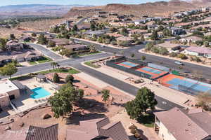 Aerial perspective of suburban area featuring mountains and a pool area