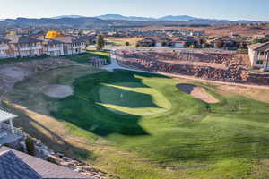 Aerial perspective of suburban area with a golf course and mountains