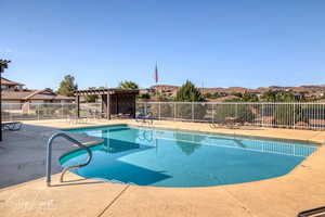 Community pool featuring a patio area and a pergola