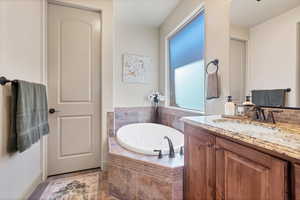 Bathroom with a bath and vanity