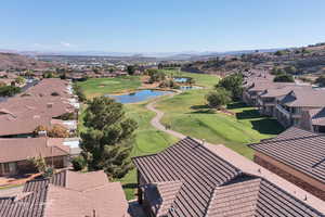Aerial perspective of suburban area featuring a local golf course and a water and mountain view