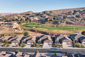 Aerial view of residential area featuring a local golf course and a mountainous background