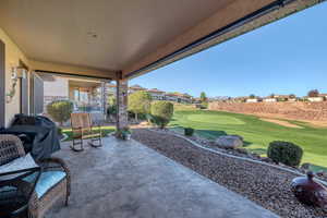 View of patio featuring an area to practice putting and golf course view