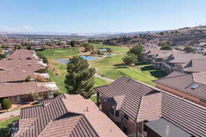 Aerial perspective of suburban area with a local golf course and a water and mountain view