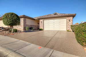 Ranch-style house with brick siding, driveway, and a garage