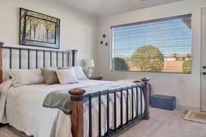 Bedroom featuring carpet and baseboards