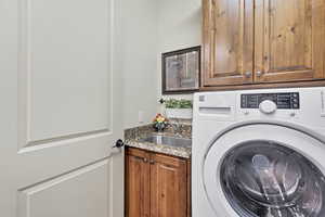 Washroom with washer / dryer and cabinet space