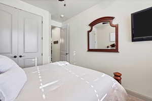 Bedroom with a closet and baseboards