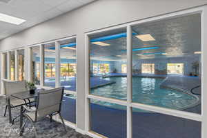 Indoor pool featuring a patio area