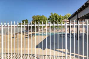 Community pool featuring a patio area and a pergola