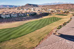 Aerial view of property's location with nearby suburban area and mountains