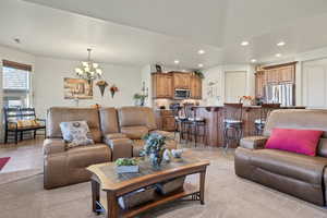 Living area with recessed lighting and a chandelier