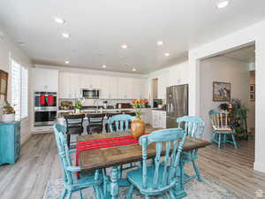 Dining space with light wood-style flooring and recessed lighting