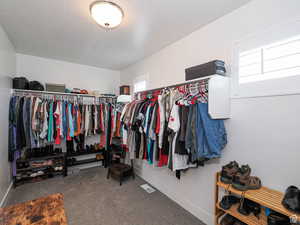 Walk in closet with carpet flooring