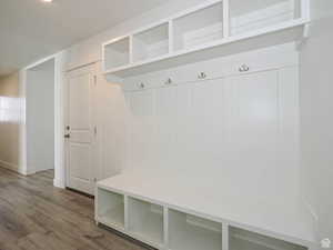 Mudroom with wood finished floors and baseboards