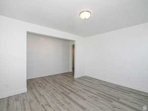 Spare room with light wood-type flooring and baseboards