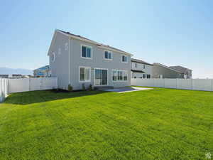 Rear view of property with a patio, a fenced backyard, stucco siding, and a mountain view