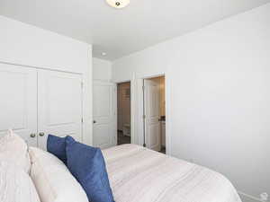 Bedroom featuring a closet and ensuite bath