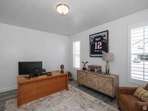 Office space featuring a textured ceiling and wood finished floors