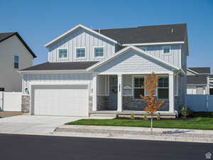 View of front of home featuring board and batten siding, a porch, and a shingled roof