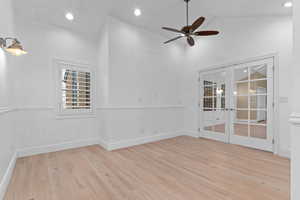 Spare room featuring french doors, light wood-style floors, a ceiling fan, high vaulted ceiling, and recessed lighting