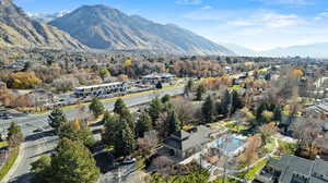 Aerial view of property's location with nearby suburban area and a mountainous background