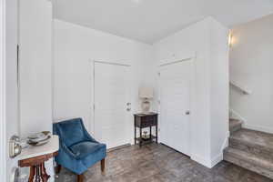 Sitting room with stairway and baseboards