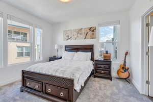 Bedroom featuring carpet and baseboards