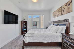 Carpeted bedroom featuring baseboards
