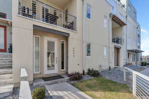 Property entrance featuring stucco siding