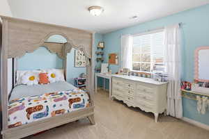 Bedroom featuring light colored carpet and baseboards