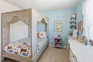 Bedroom featuring light colored carpet and baseboards