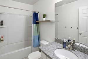 Full bathroom featuring shower / bath combination with curtain and vanity