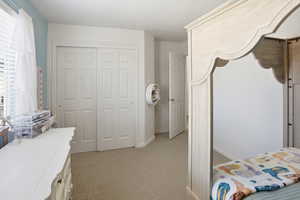 Bedroom featuring a closet and light carpet