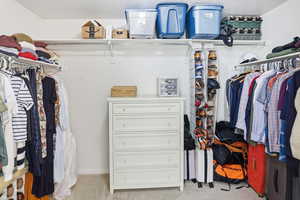 Walk in closet with light carpet