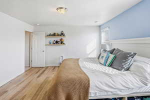 Bedroom featuring light wood-style flooring and baseboards