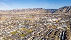 Aerial view of property's location with a mountainous background and nearby suburban area