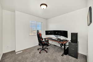 Carpeted office space with baseboards