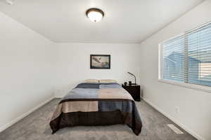 Carpeted bedroom featuring baseboards